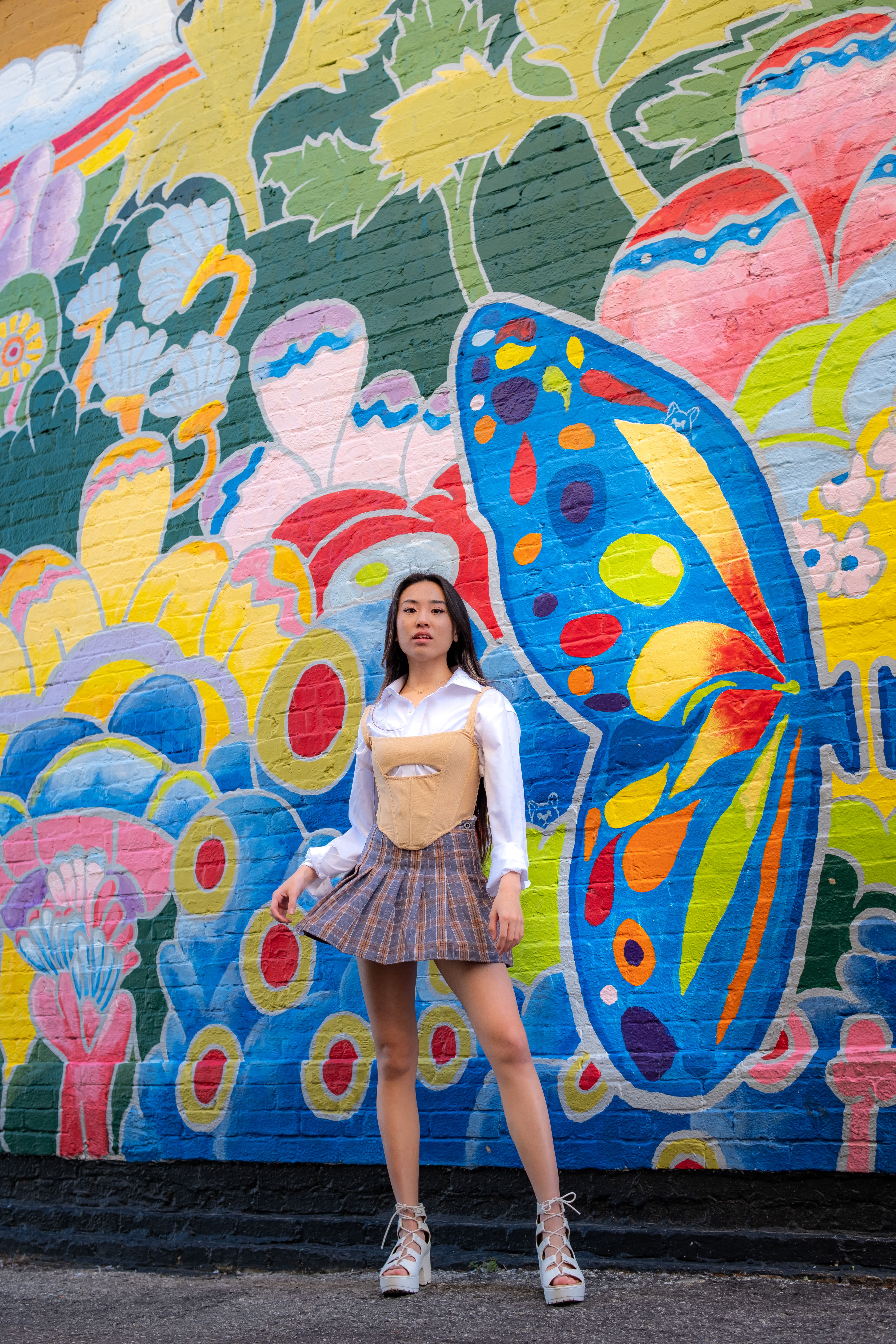 A Woman Standing in Front of a Mural · Free Stock Photo