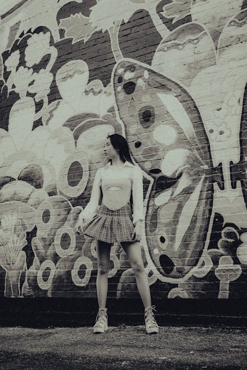 Woman Standing by Wall with Graffiti in Black and White