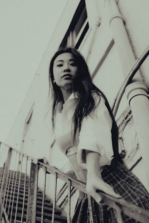 Grayscale Photo of Woman on Stairs 