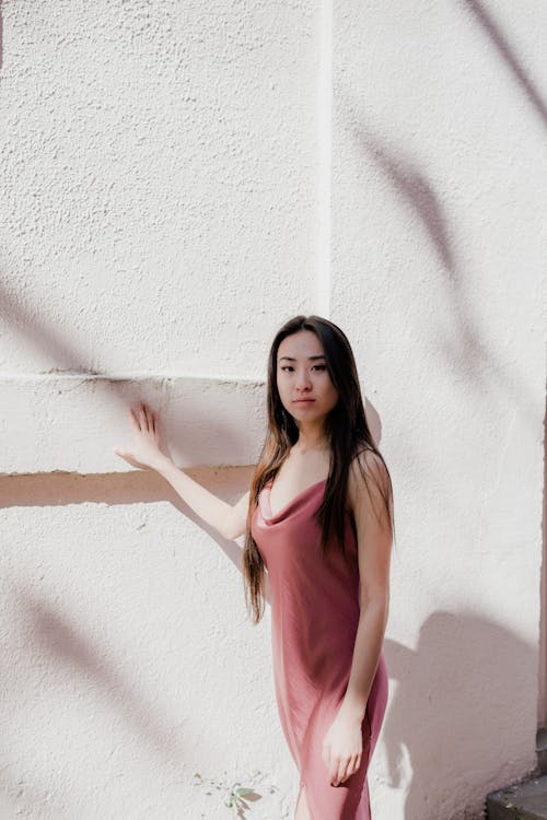 Standing Woman Holding Hand on Wall