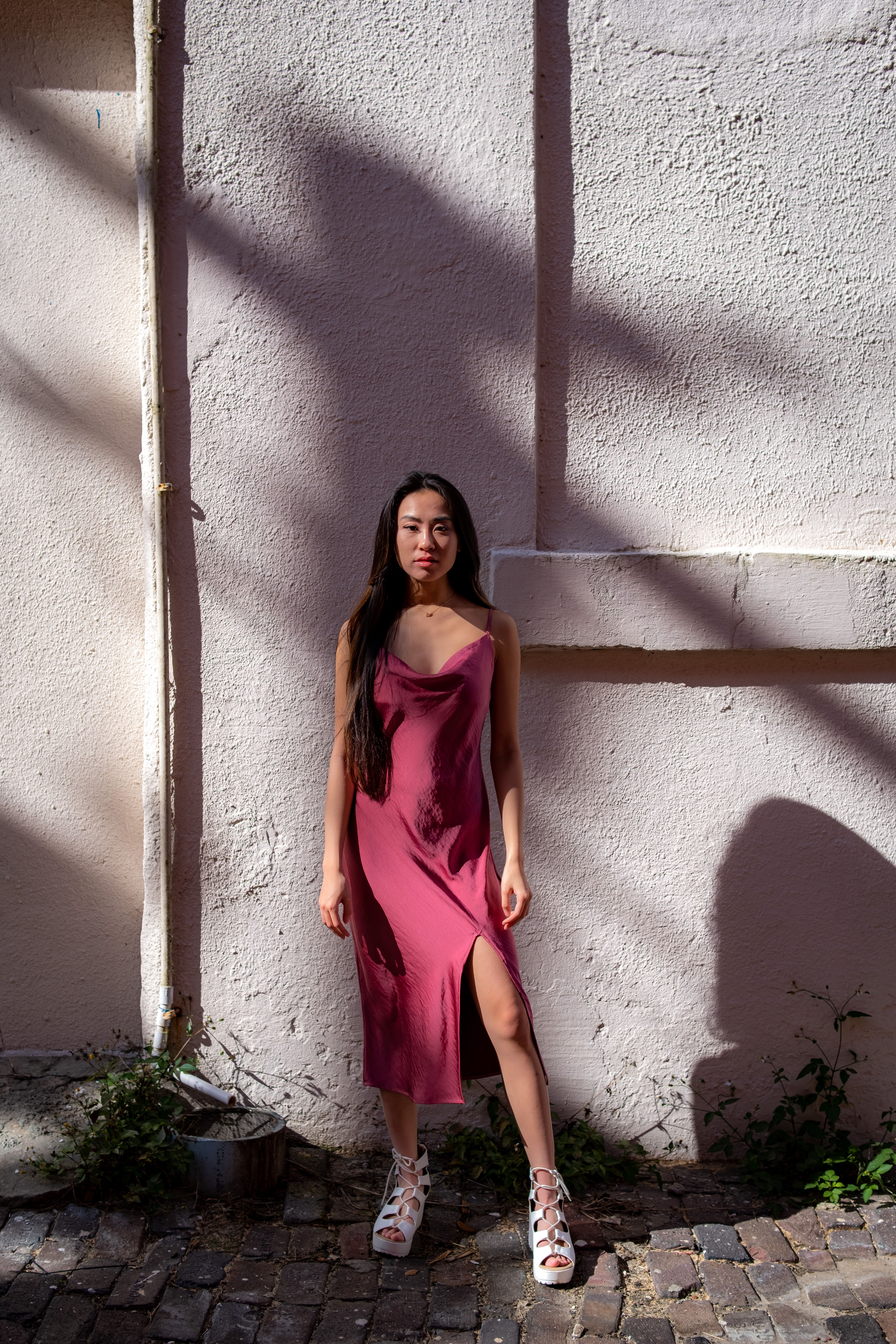Woman in Pink Dress leaning on Steel Structure · Free Stock Photo