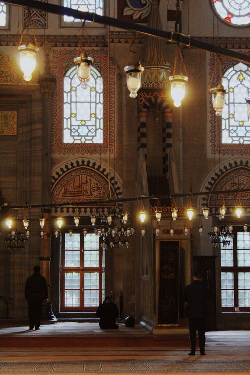 Free Atmospheric mosque interior showcasing intricate designs and peaceful ambiance, with people praying. Stock Photo