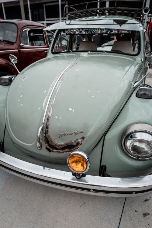 Free Classic vintage Volkswagen Beetle with a retro charm, parked in an urban area. Stock Photo