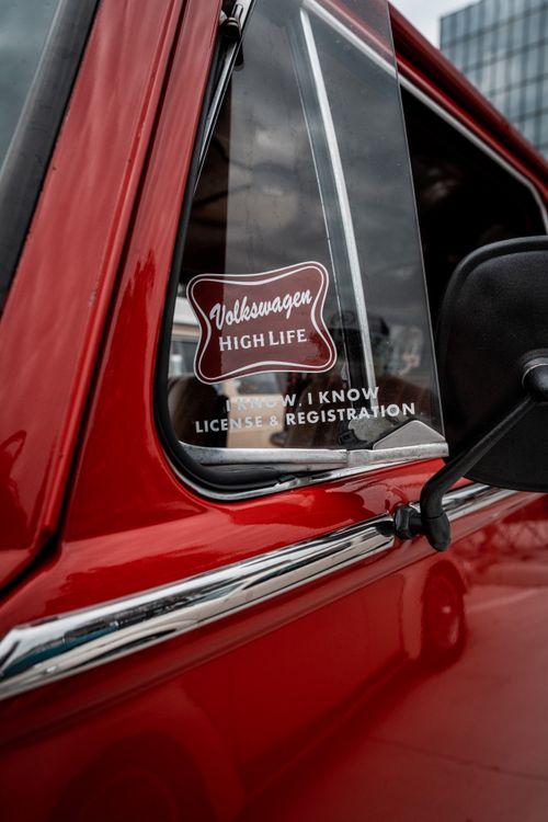 Stickers On The Vent Window Of A Red Classic Volkswagen Beetle Free stickers-on-the-vent-window-of-a-red-classic-volkswagen-beetle-free