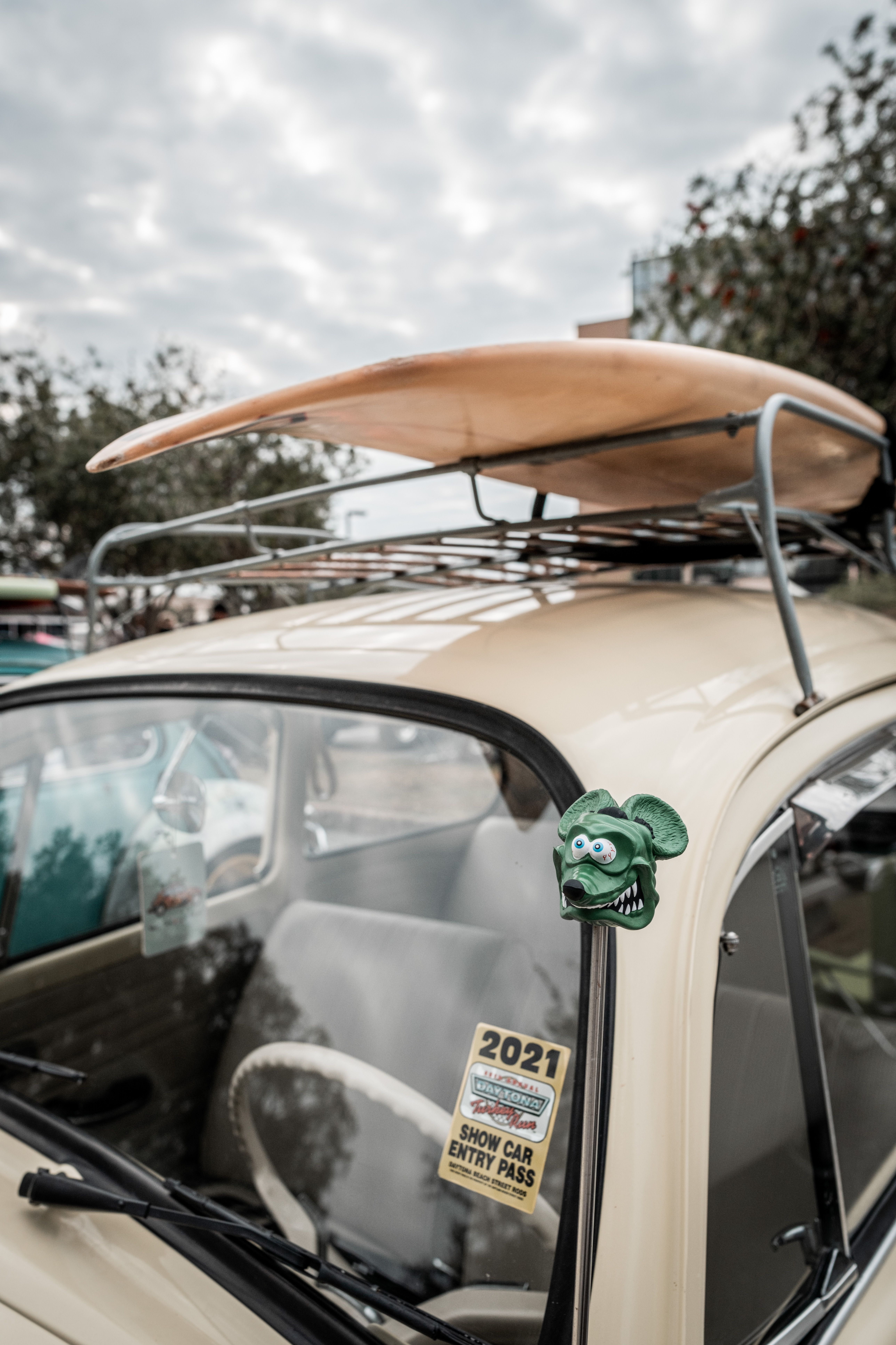 Surfboard on the Roof Rack of a Cream Volkswagen Beetle with a Green ...