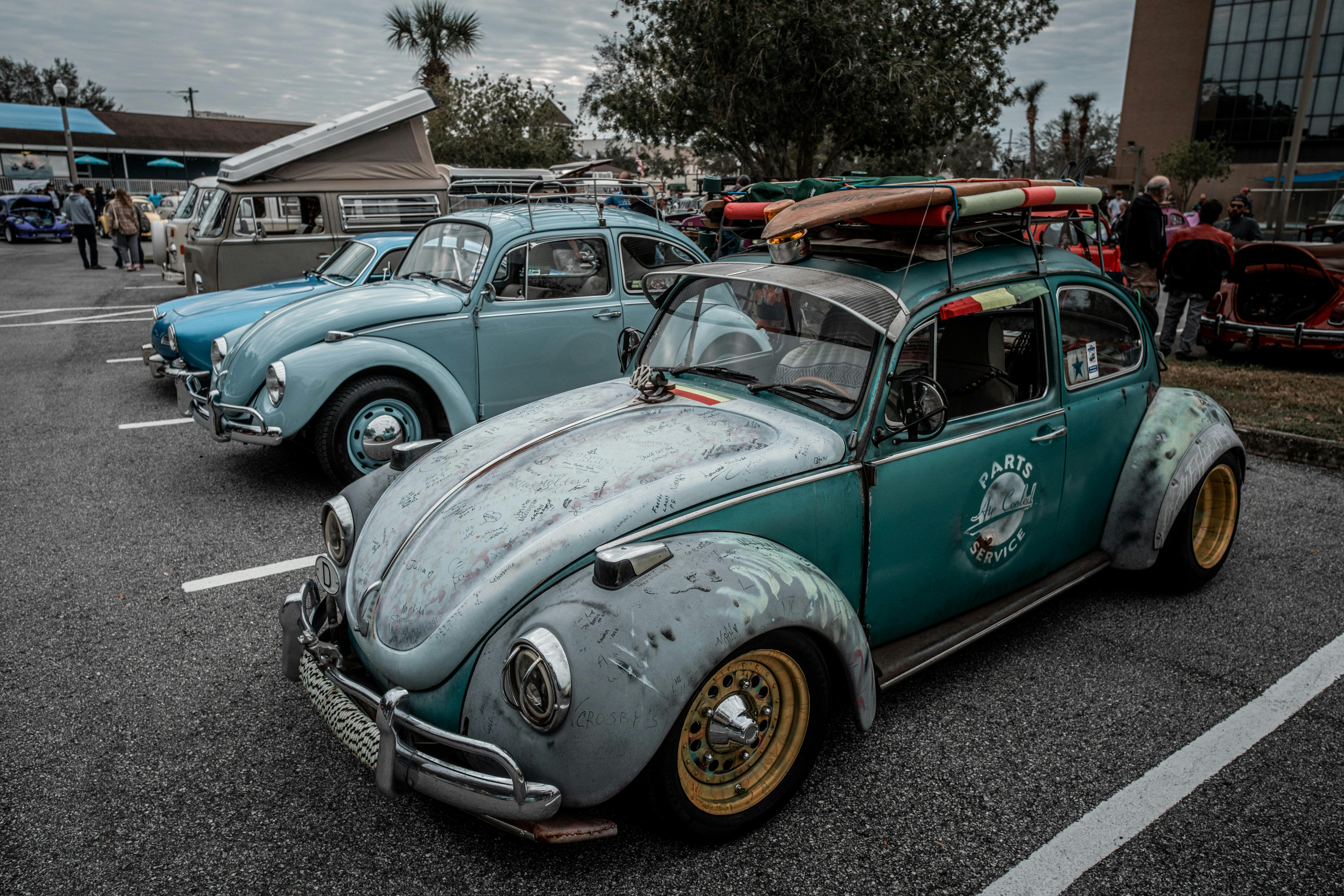 surfboard on the roof rack of a visually modified classic volkswagen beetle