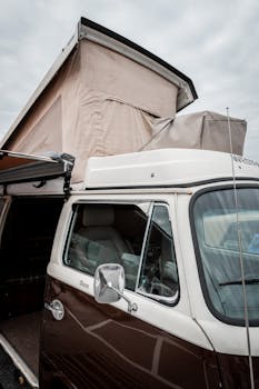 Close-up of a restored vintage Volkswagen camper with pop-up roof, perfect for travel enthusiasts.