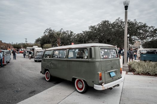 A nostalgic scene of classic Volkswagen vans parked outdoors during a car event.