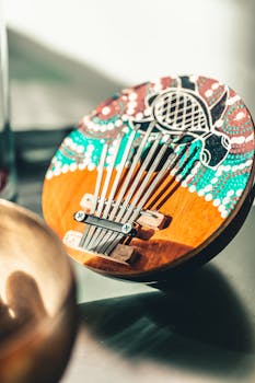Close-up of a wooden kalimba with vibrant, hand-painted patterns.