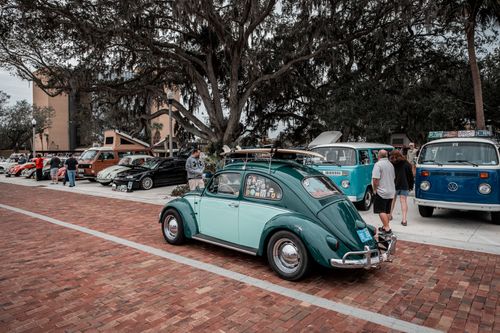 Free Classic Volkswagen Beetle with surfboard at a vintage car show outdoors. Stock Photo