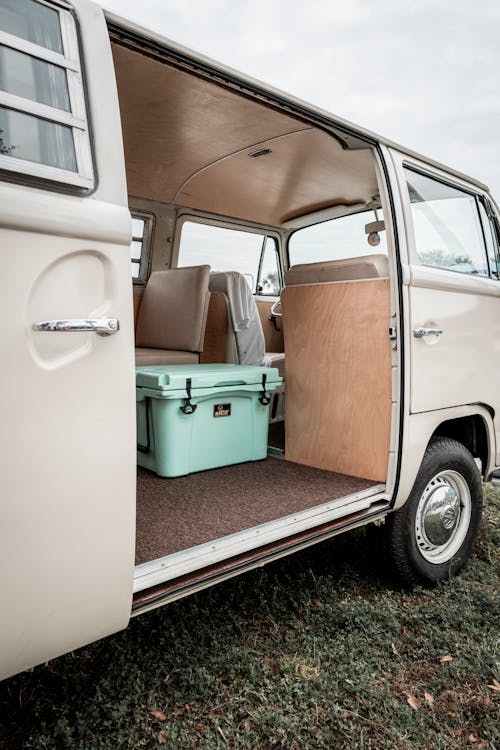 Free Vintage camper van with an open door revealing a cozy interior. Stock Photo