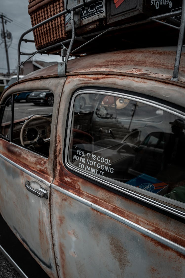 Rusty Volkswagen Beetle With Funny Sign