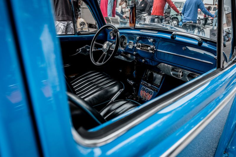 Explore the classic interior of a vintage blue Volkswagen Beetle, a nostalgic automotive icon.