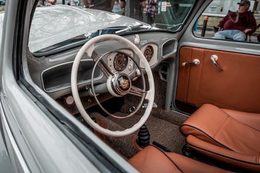 Explore the retro charm and elegant design of a vintage Volkswagen Beetle's interior with brown leather seats and classic dashboard.