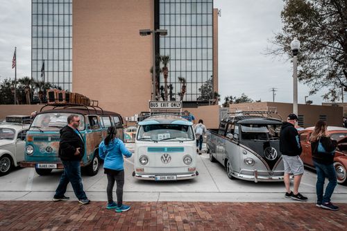 Free Retro Volkswagen vans and cars gathered for a car meet in city parking space. Stock Photo