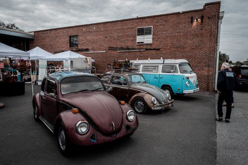 Free Classic Volkswagen Beetles and minivan showcased at an urban motor show. Stock Photo