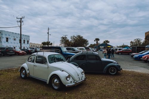 Free Vintage Volkswagen Beetles parked outdoors at an urban car meet. Stock Photo