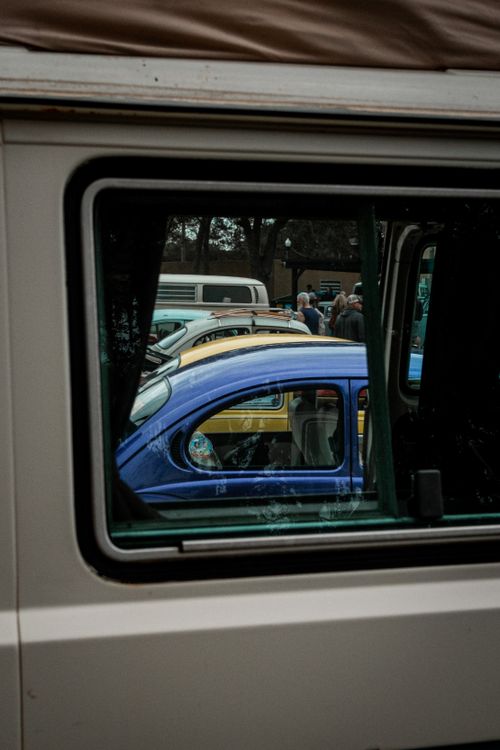 Free A unique view of classic cars through a van's window at a car show. Stock Photo