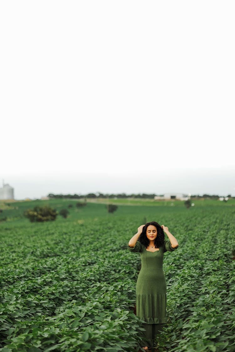 Woman In Green Dress Posing In Field