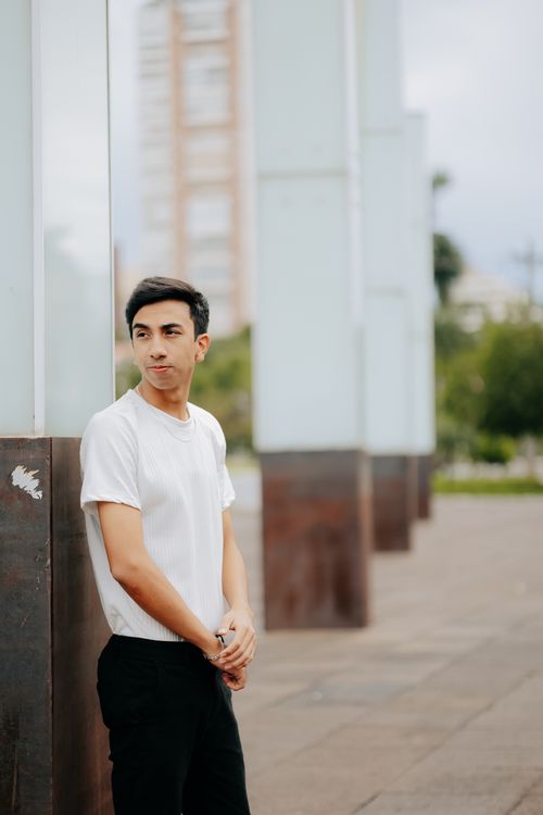 Free Young man in casual outfit posing against urban architectural structures. Stock Photo