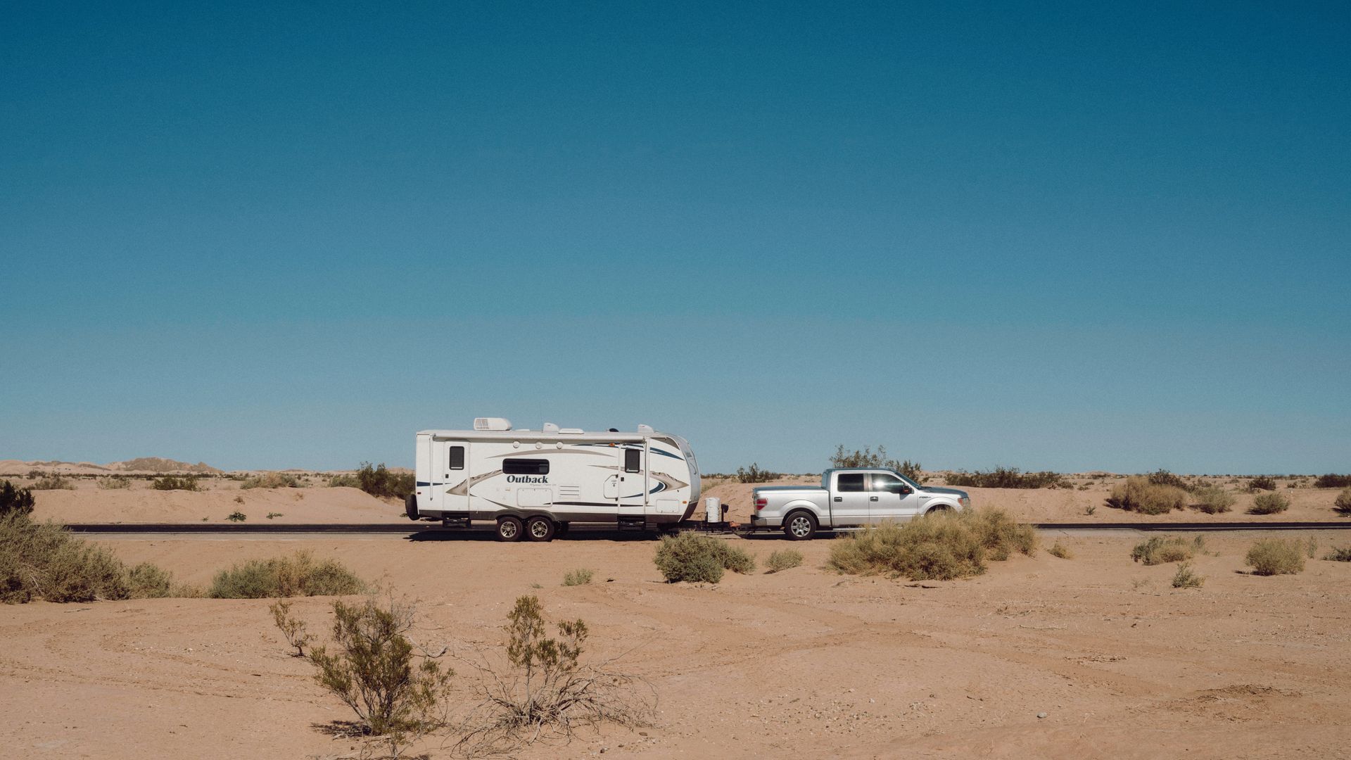 An RV at sunset in the Southern California desert, illustrative of the regional RV rental market.
