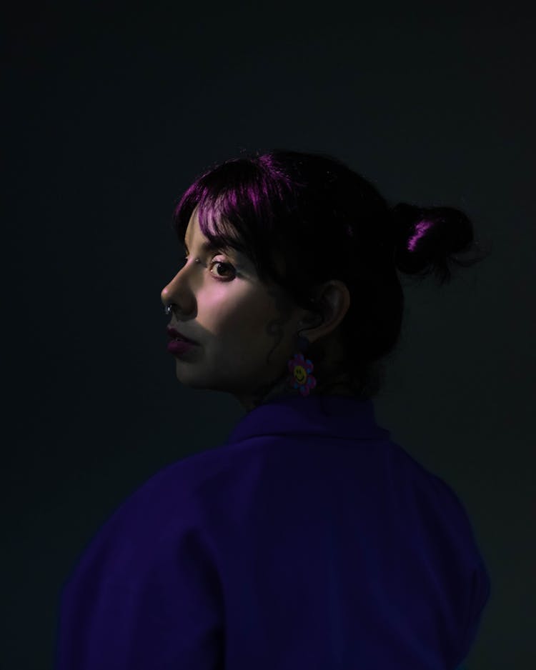 Light On Girl Face Posing In Dark Studio