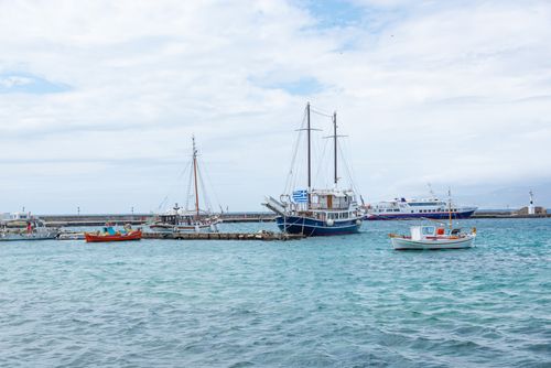 Free Peaceful view of boats docked at a coastal harbor under a cloudy sky. Stock Photo