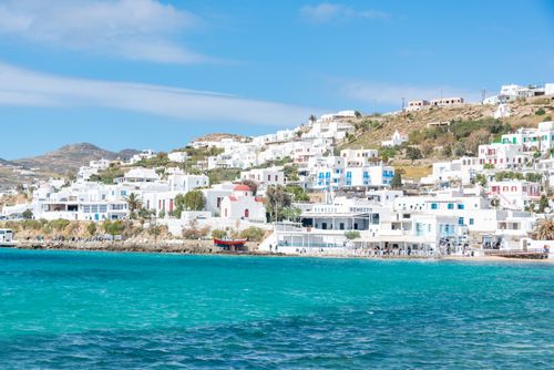 Free Beautiful view of Mykonos' iconic whitewashed buildings along the vibrant turquoise coast. Stock Photo