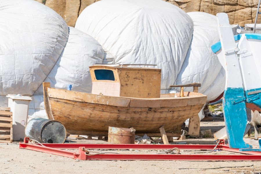 Wooden hull under construction in a beach yard — photo by Diego F. Parra on Pexels