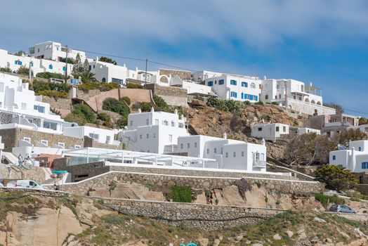 Scenic view of iconic white houses on a Greek hillside, showcasing traditional architecture.