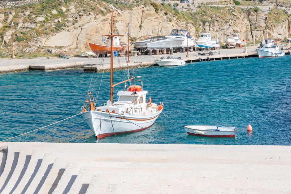 Outstanding Private All Included Yacht Tour in Santorini Review: A Luxurious 3-Hour Caldera Experience Review 2026 - Idyllic scene of a tranquil harbor with fishing boats and clear blue water.