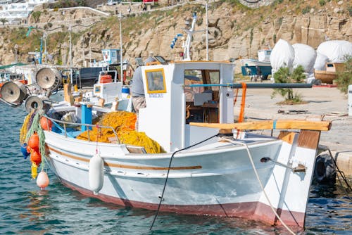 Boat in Port near Cliff