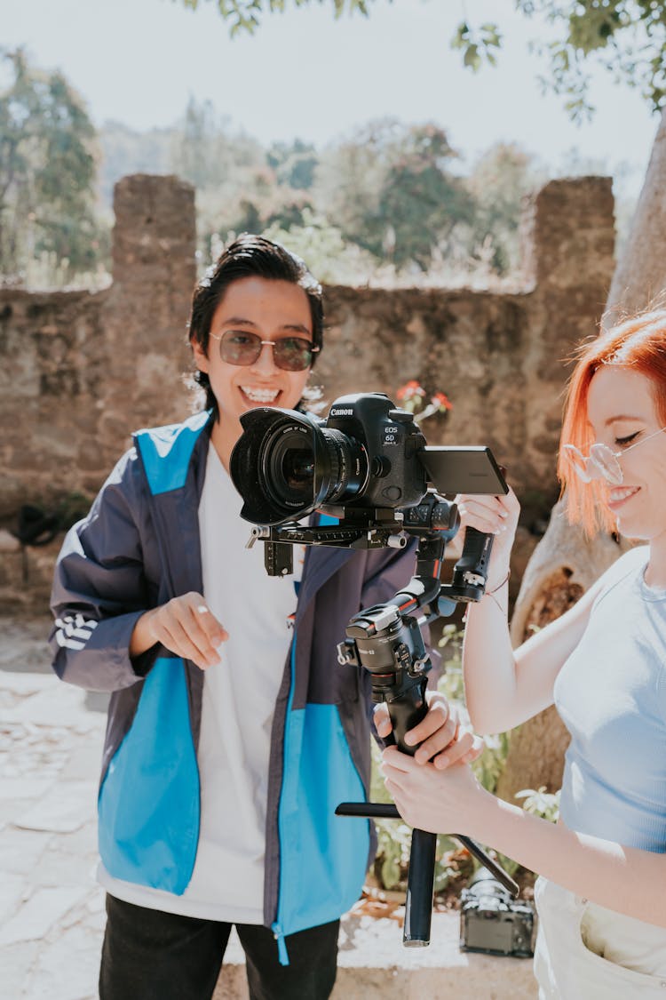 Smiling Woman And Man With Camera