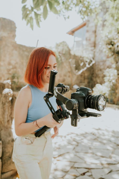 Woman Operating a Professional Camera 