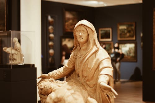 Close-up of a Sculpture of Mary Holding Jesus in a Museum 