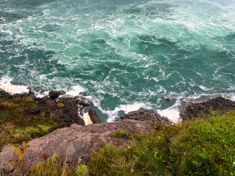 A breathtaking view of the rocky edge and turbulent waters at Niagara Falls, ON, Canada.