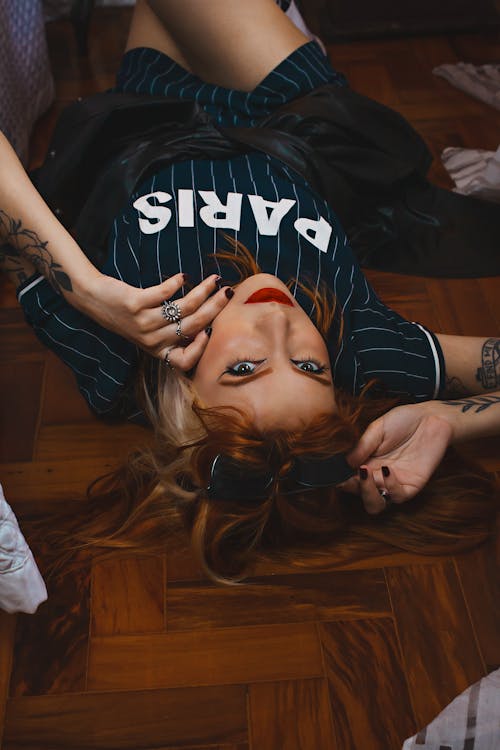 Tattooed Young Woman Lying on the Floor