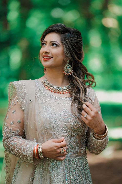 Free A smiling woman in a stunning traditional dress, captured beautifully outdoors. Stock Photo