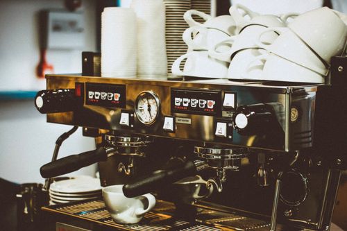 Free Image of a professional espresso machine with cups in a cozy café environment. Stock Photo