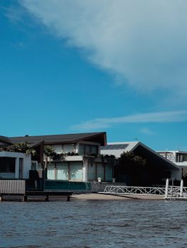 Contemporary lakeside house in Noosa Heads, featuring solar panels and waterside dock.