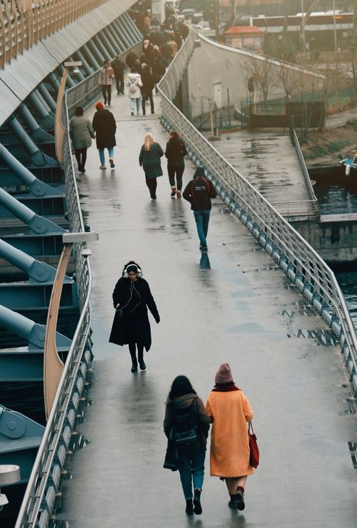 Free People walking on a contemporary bridge in the city, showcasing urban connection. Stock Photo