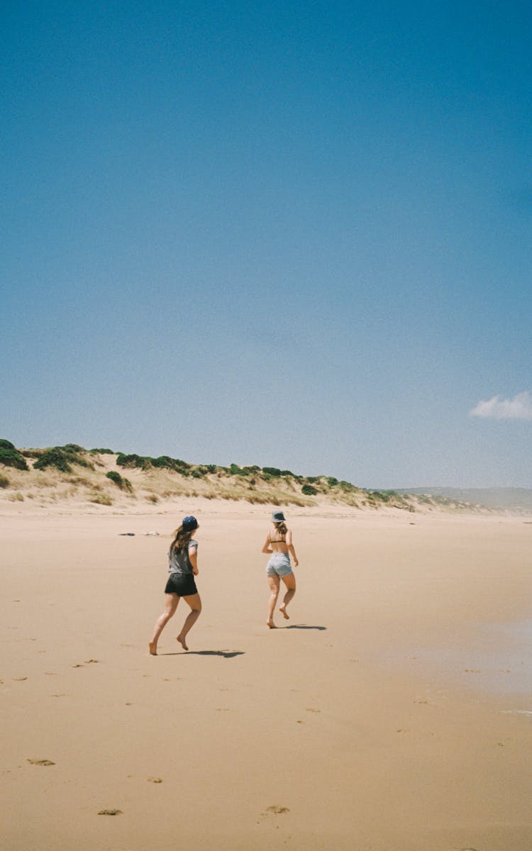 Women Running Along Beach