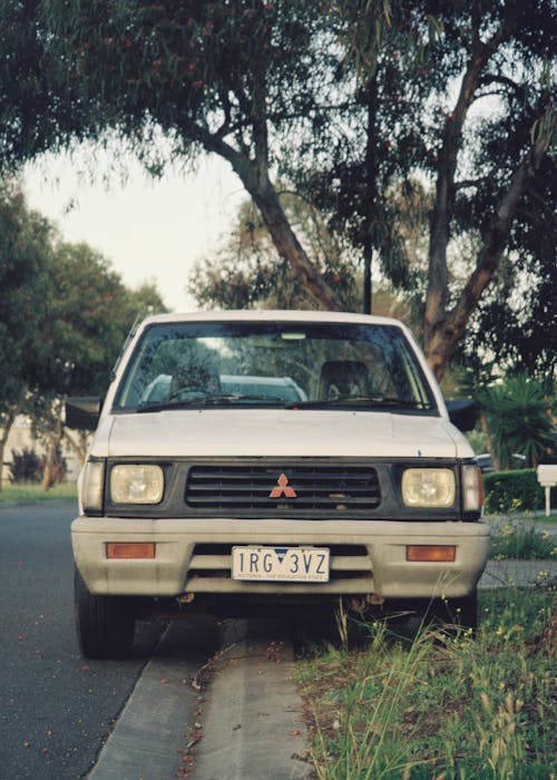 A Vintage Mitsubishi L200 Parked on the Side of a Street in City 