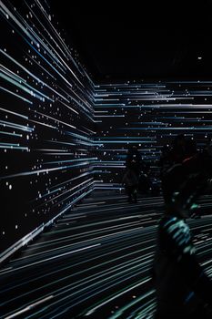 An intriguing abstract light installation with figures silhouetted against projecting lights in Istanbul.