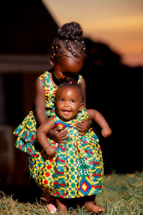 Cute Girls in Traditional Dresses Posing in Nature on Sunset