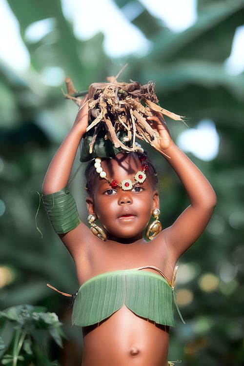 Free Cute child wearing leaf costume posing playfully outdoors in a natural setting. Stock Photo