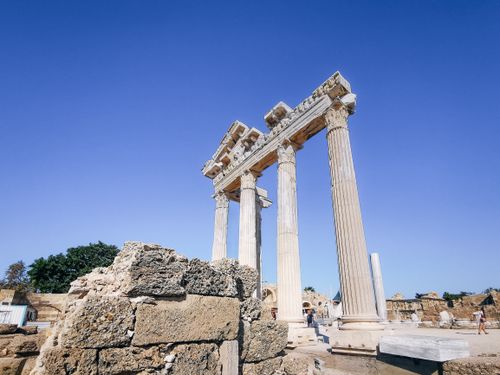 Free Explore the grandeur of ancient Greek ruins with stunning marble columns under a clear blue sky. Stock Photo