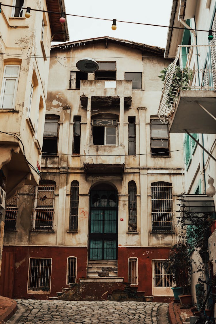 An Abandoned Building With Broken Glass Windows