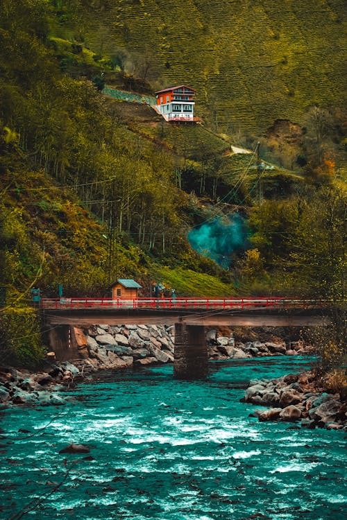 Free River and Bridge in Village on Hill Stock Photo