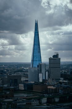 A striking view of The Shard amidst clouds over London's skyline.